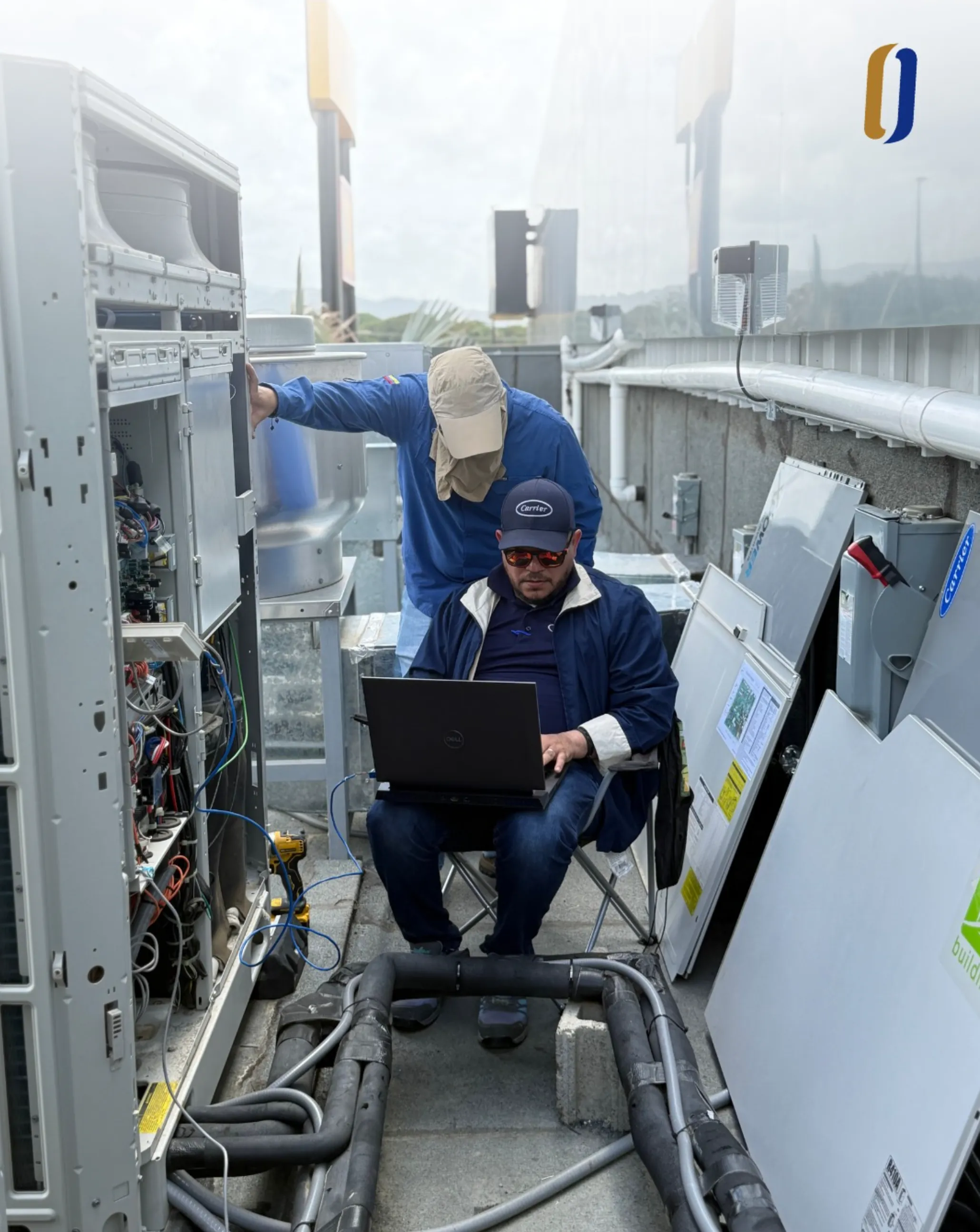 ODESA technician diagnosing a Carrier unit with a laptop