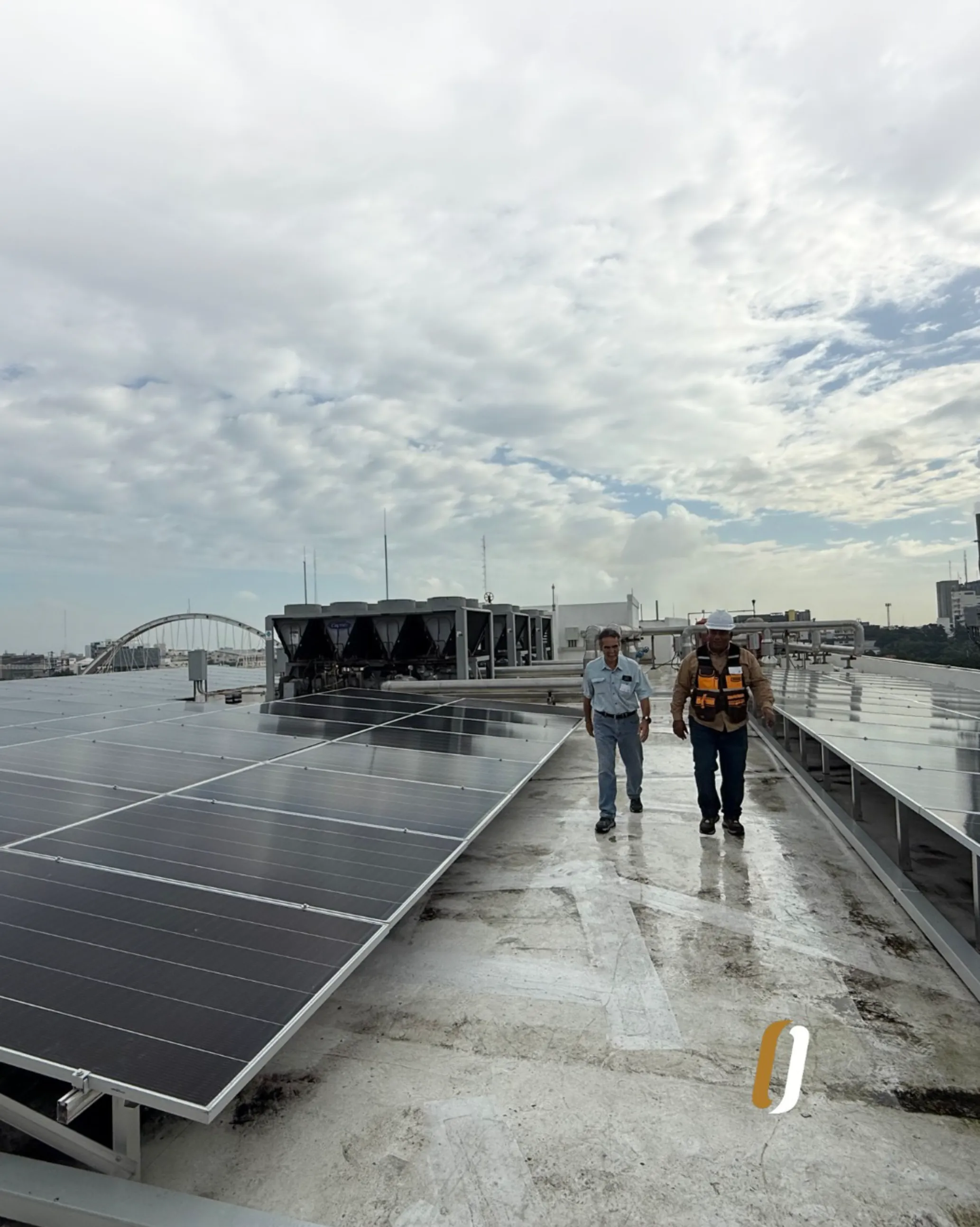 ODESA technicians inspecting rooftop chillers and solar panels