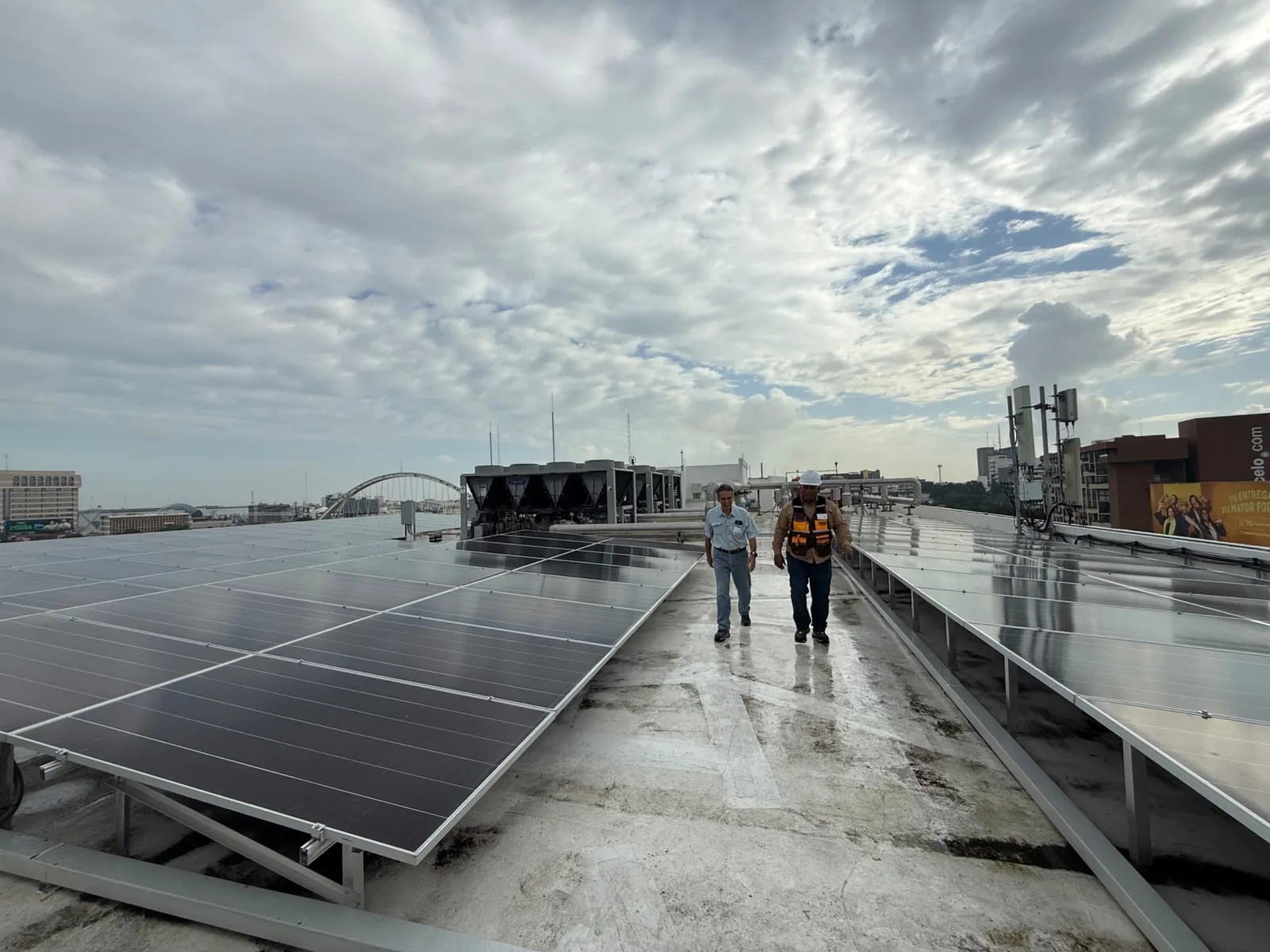 ODESA technicians inspecting rooftop chillers and solar panels